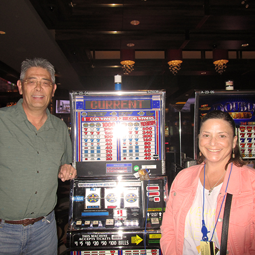 Winner Allan W Standing by Slot Machine